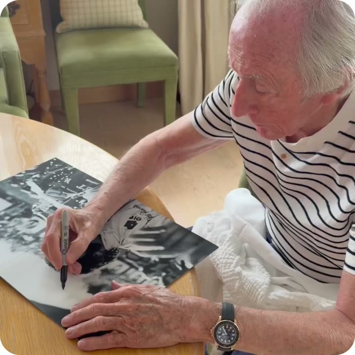 Sir Jackie Stewart signing a Framebook print
